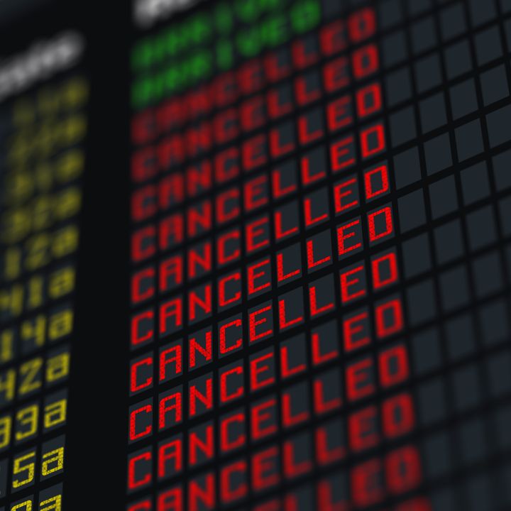 A flight status board with rows of canceled flights.