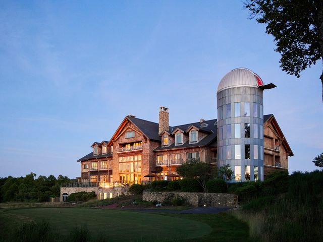 A hotel with a silo on the side that opens up as an observatory to view the night sky on top.