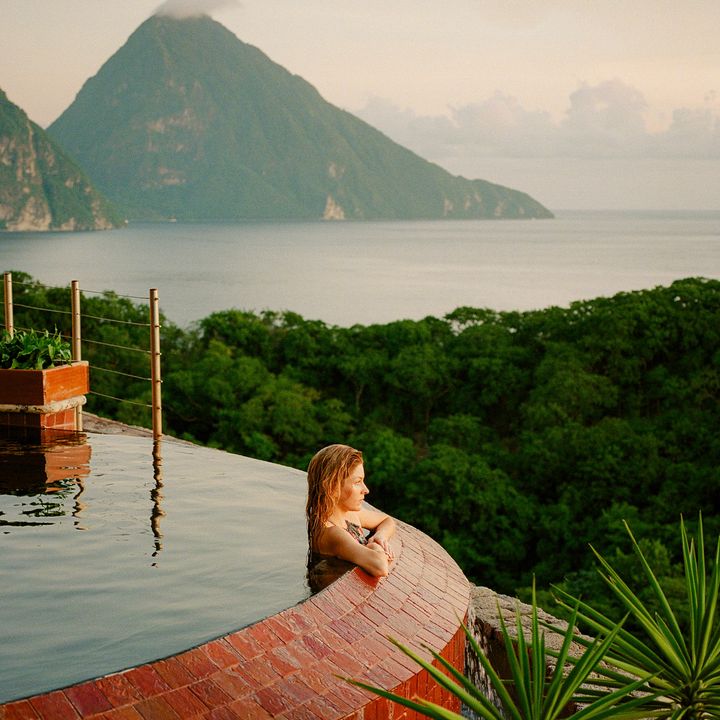 A woman at the edge of a private infinity pool at Jade Mountain Resort in St. Lucia.