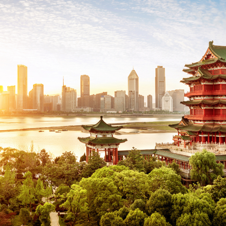 A skyline of an Asian city on the waterfront.