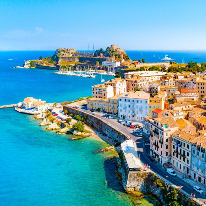 An aerial view over a city and coastline in Corfu, Greece.