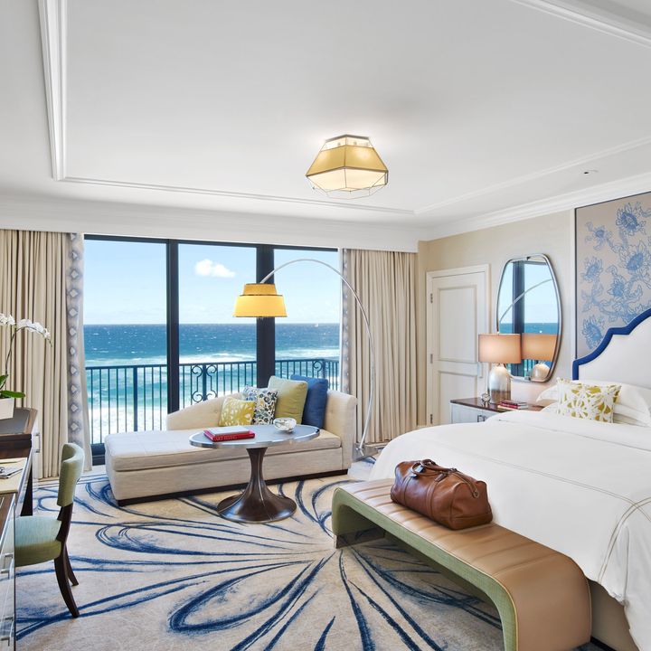 A stylish hotel room at The Breakers Palm Beach with views of the ocean.