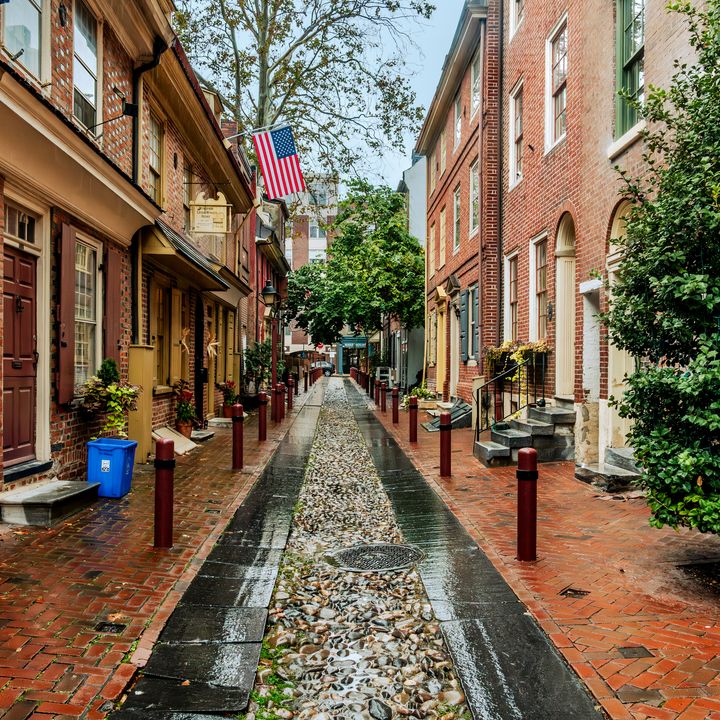 The historic Elfreth's Alley in Philadelphia lined with brick buildings.