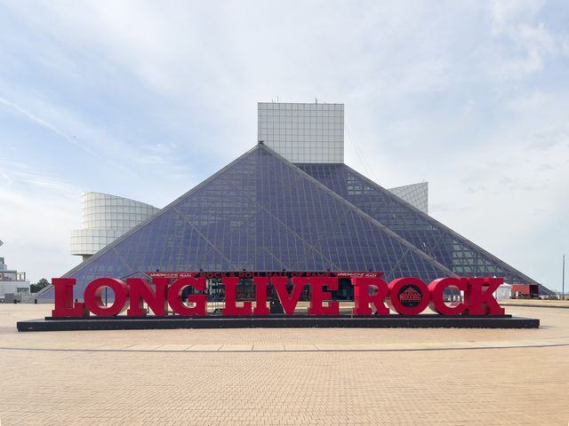 The exterior of the Rock & Roll Hall of Fame with big block letters that say Long Live Rock.