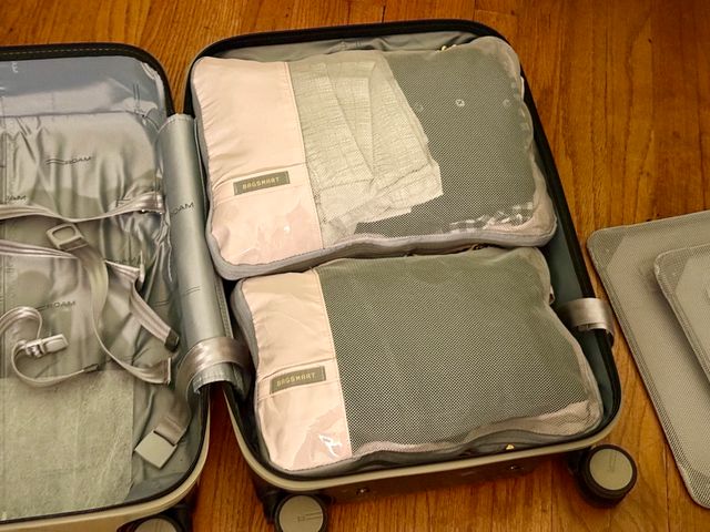 Two full packing cubes inside one clamshell half of a suitcase.