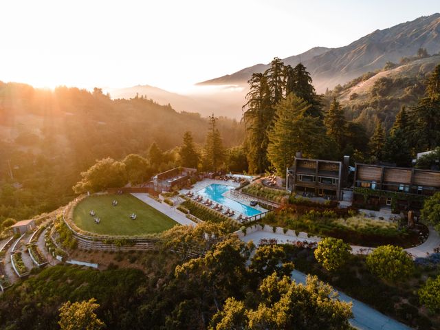 An aerial view of Alila Ventana Big Sur grounds with a building and pool amid the wilderness.