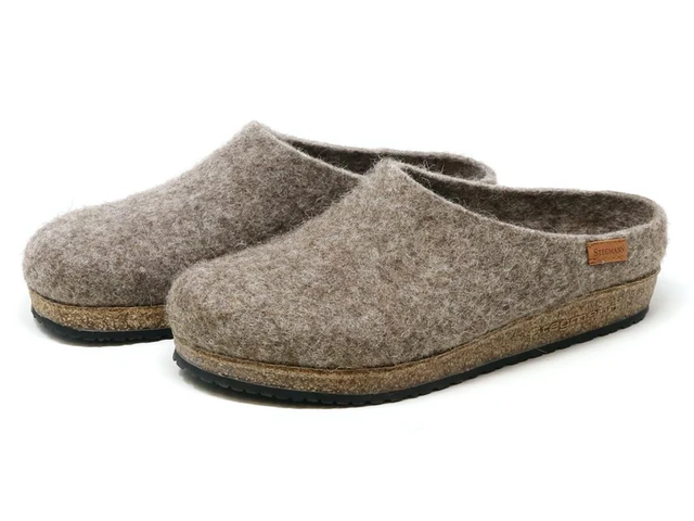 Grey wool clog shoes against a white background.