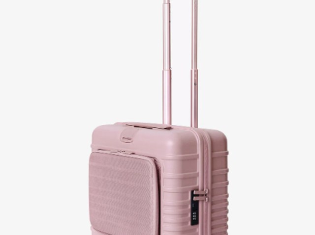 A child's pink Beis suitcase against a white background.