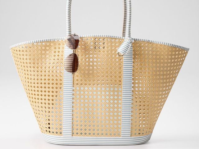 Mark & Graham cane tote with white accents and aviator sunglasses tucked onto strap