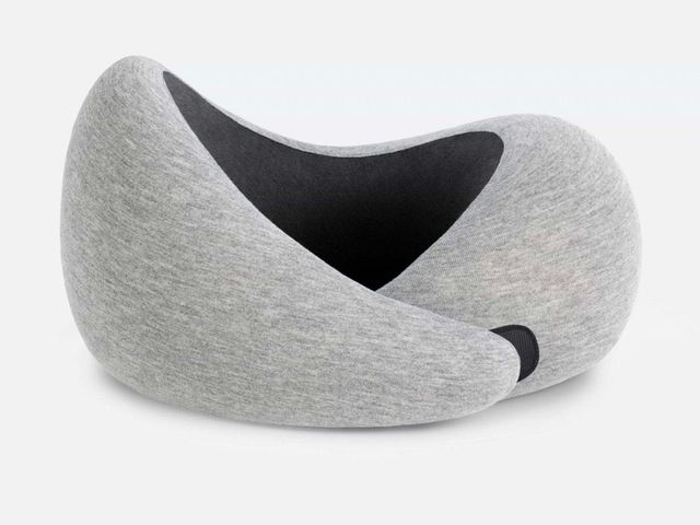 An ergonomic grey neck pillow against a white background.