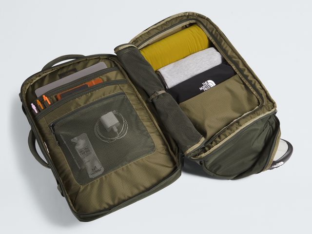 A large travel pack open clamshell-style to show contents neatly packed, against a white background.