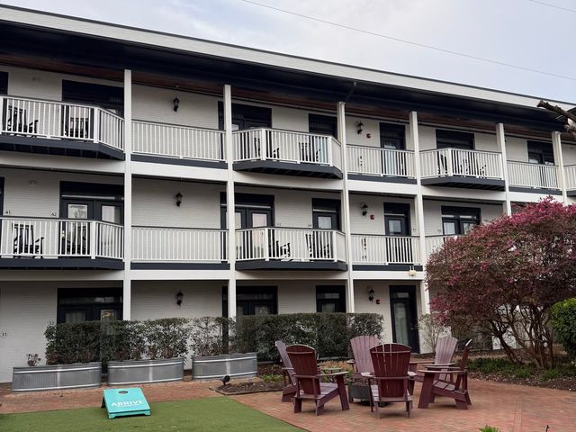 The exterior of Arrive Wilmington hotel with its white walls and balconies.