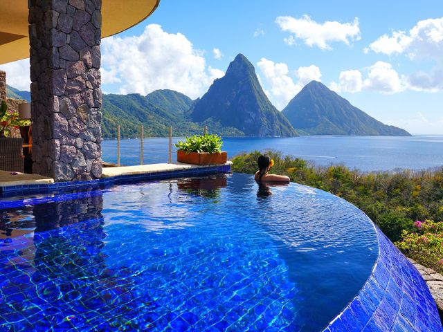 A person at the edge of their private infinity pool at Jade Mountain Resort in St. Lucia.