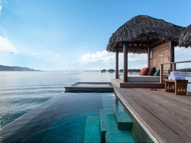 An overwater bungalow with an infinity pool facing the ocean.