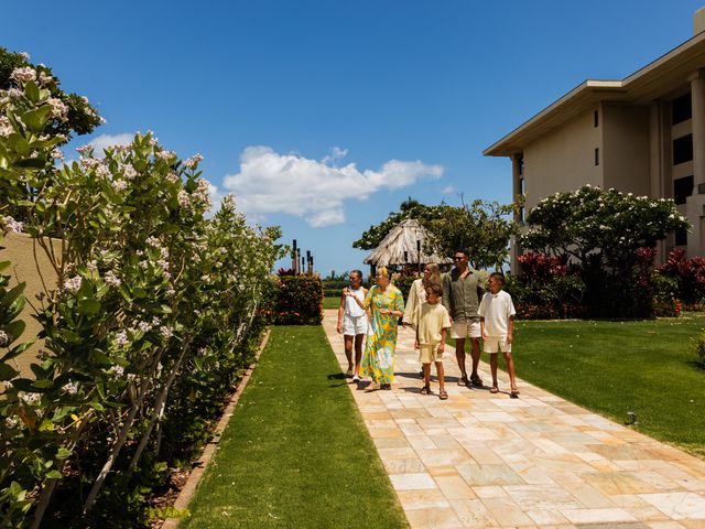 A woman leads a family on a tour of a garden at the Four Seasons Resort Maui.