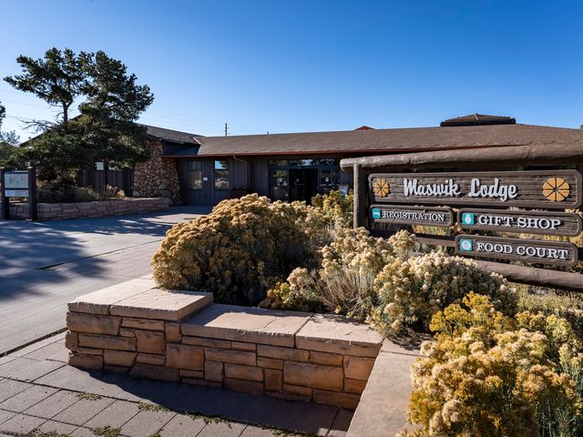 The exterior for Maswik Lodge with a sign outside.