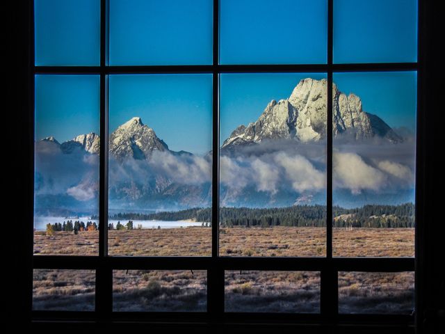 A view of the Grand Tetons through the window at Jackson Lake Lodge in Wyoming.