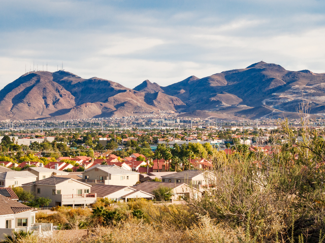 Aerial view of Henderson, Nevada with homes and mountains in the background.
