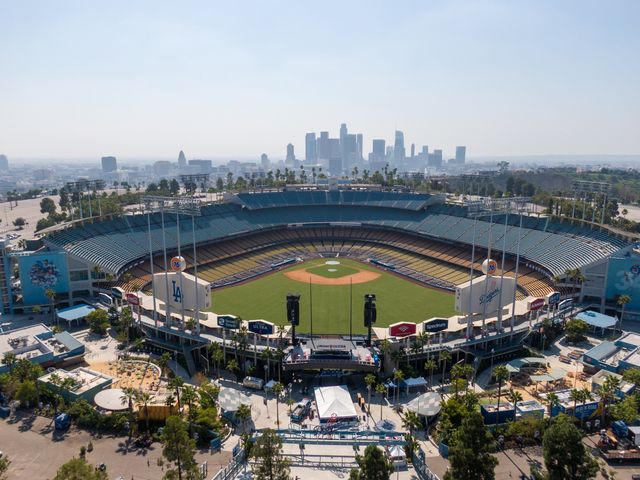 An overhead view of Dodger Stadium with the LA skyline in the background.