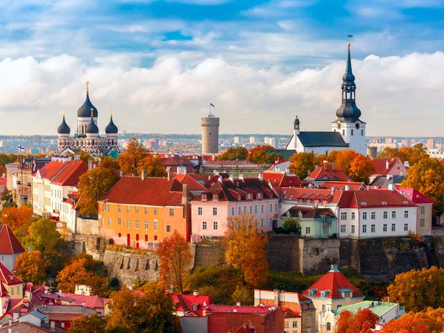 An aerial view of old town, Tallinn in Estonia with many red roofs and domed buildings.