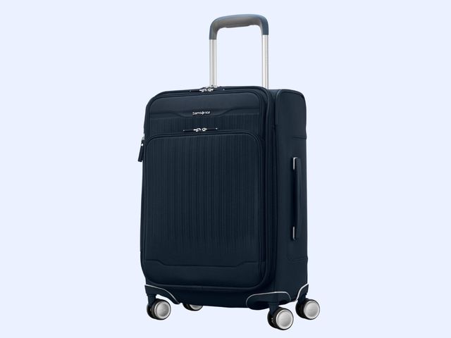 A black soft-sided wheeled carry-on suitcase against a blue background.