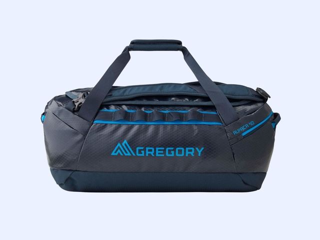 A grey duffel bag with bright blue accents labeled 'Gregory' against a blue background.