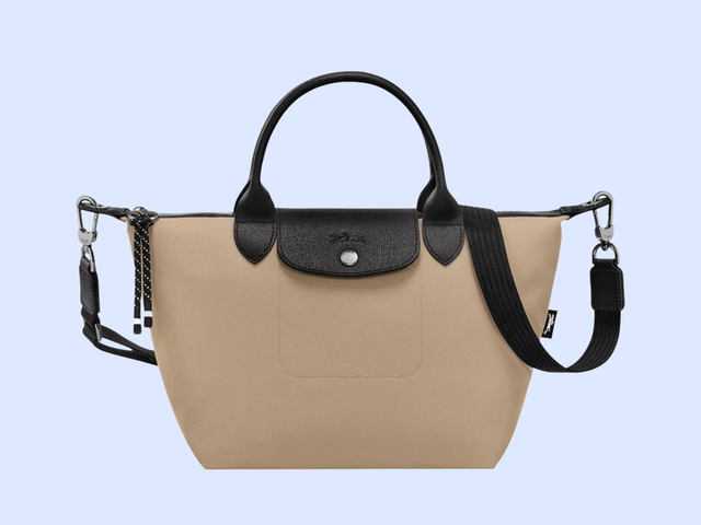 A tan nylon bag with dark straps against a white background.
