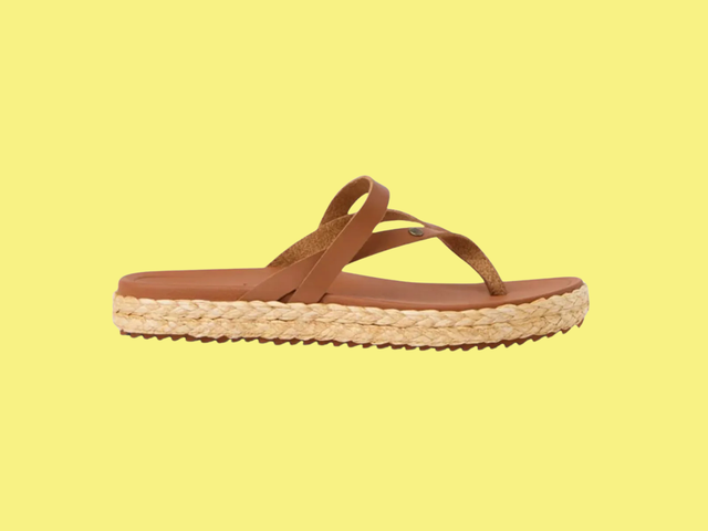 A sandal with strappy brown upper portion and a braided espadrille bottom.