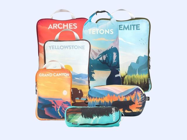 Six packing cubes, each themed after a different national park, against a blue background.