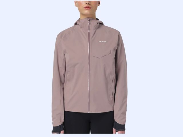 A person wearing a mauve rain jacket is visible from the nose to just below the hip.