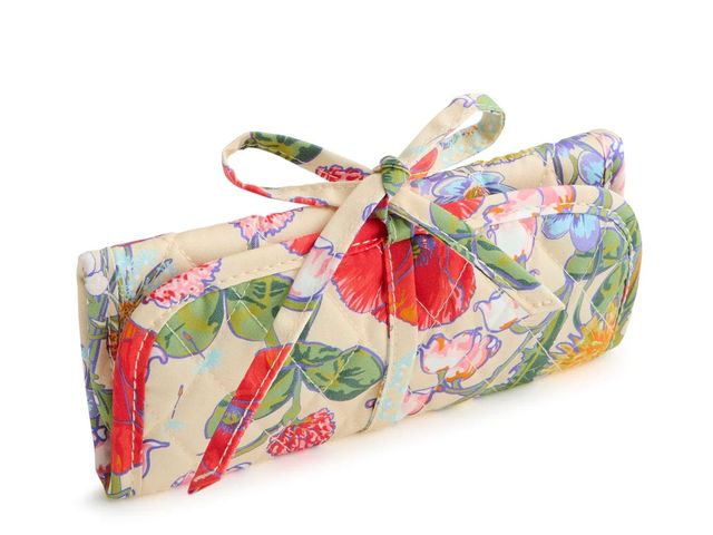 A quilted folded-up case with a plush fabric exterior tied with a bow.
