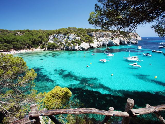 A view of "Macarelleta" beach, one of the most beautiful spots in Menorca, Balearic Islands, Spain, with turquoise waters and bluffs.