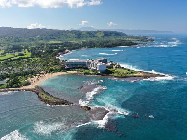 An aerial view over the hotel, grounds, and ocean at The Ritz-Carlton Oahu, Turtle Bay.