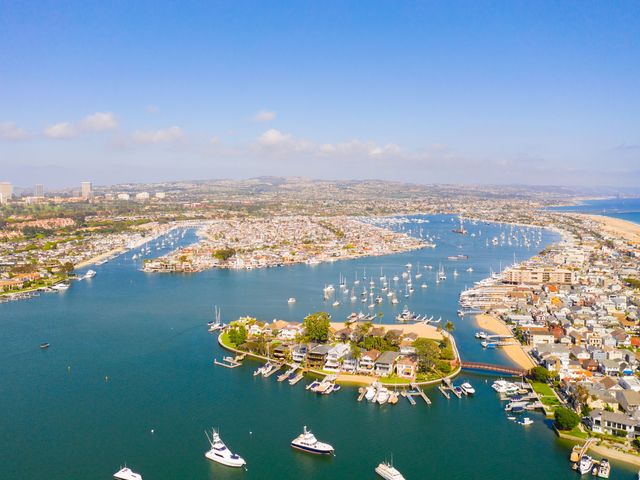 An aerial view drone shot over Balboa Island and the harbor in Newport Beach.
