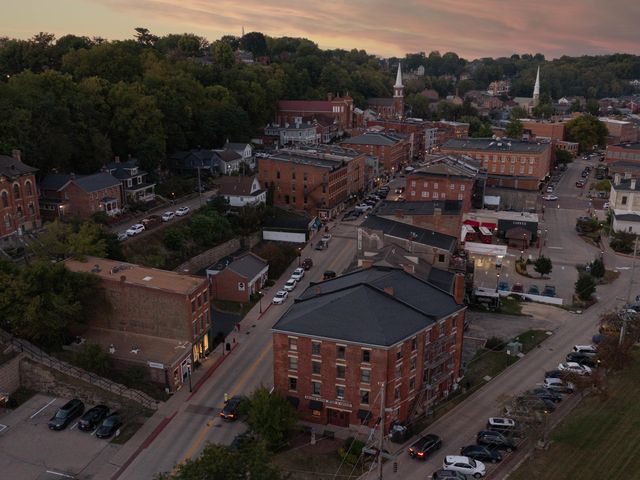 An aerial view over the downtown area of Galena, Illinois and many red brick buildings, at dusk.