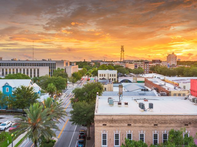 An aerial view over the Gainesville cityscape at sunset.