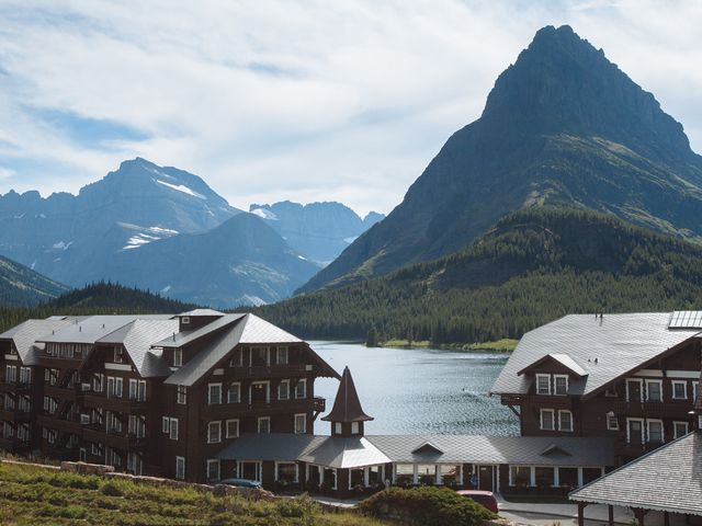 The historic Many Glacier Hotel overlooking the water and mountains of Glacier National Park in Montana.