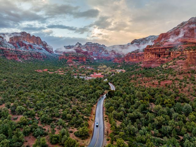 A road leading into the Enchantment Resort as seen from above surrounded by dramatic red rock formations.