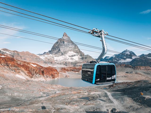 A cable car passes in the foreground of the Matterhorn in Switzerland.