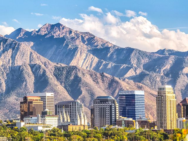 A view of the Salt Lake City skyline with mountains in the background.