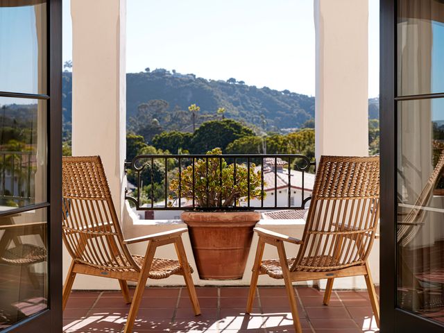 Two chairs on a balcony with scenic views at Kimpton Canary Hotel.