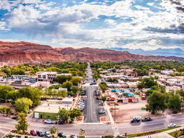 An aerial view over the main street in downtown Moab, Utah, surrounded by red rock scenery.