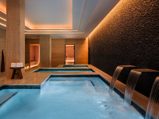 The vitality pool with waterfall features at the Ka Holo Spa at the Four Seasons Resort Maui.