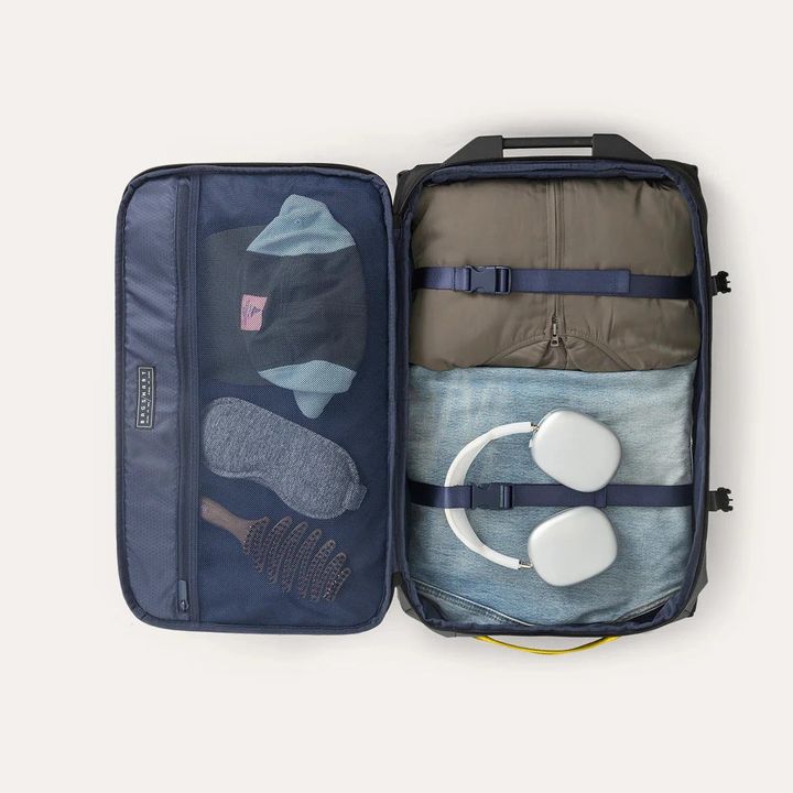 A duffel bag lies open clamshell-style against a white background.