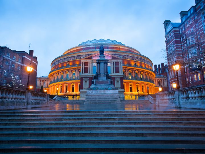Steps leading up to the Royal Albert Hall Opera theater in London, England, at dusk.