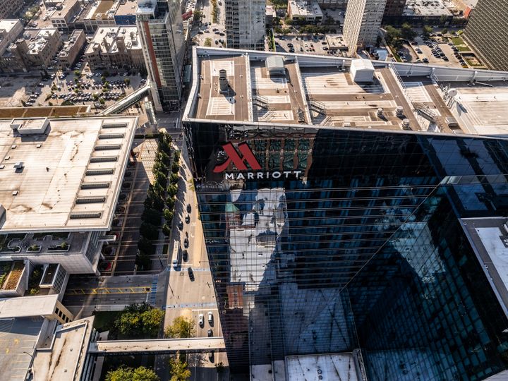 An aerial view looking down over a Marriott hotel set in an urban city.