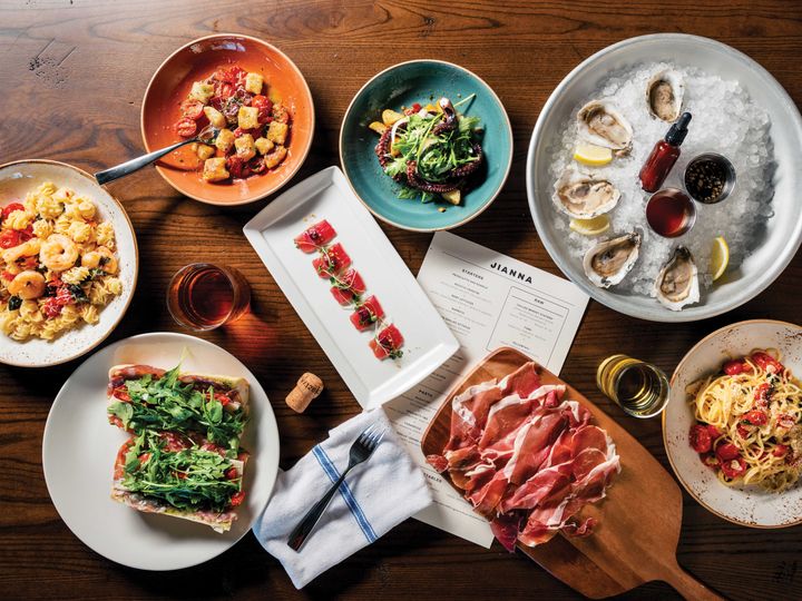 An overhead shot of a table artfully posed with plates of food.