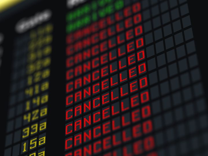 A flight status board with rows of canceled flights.