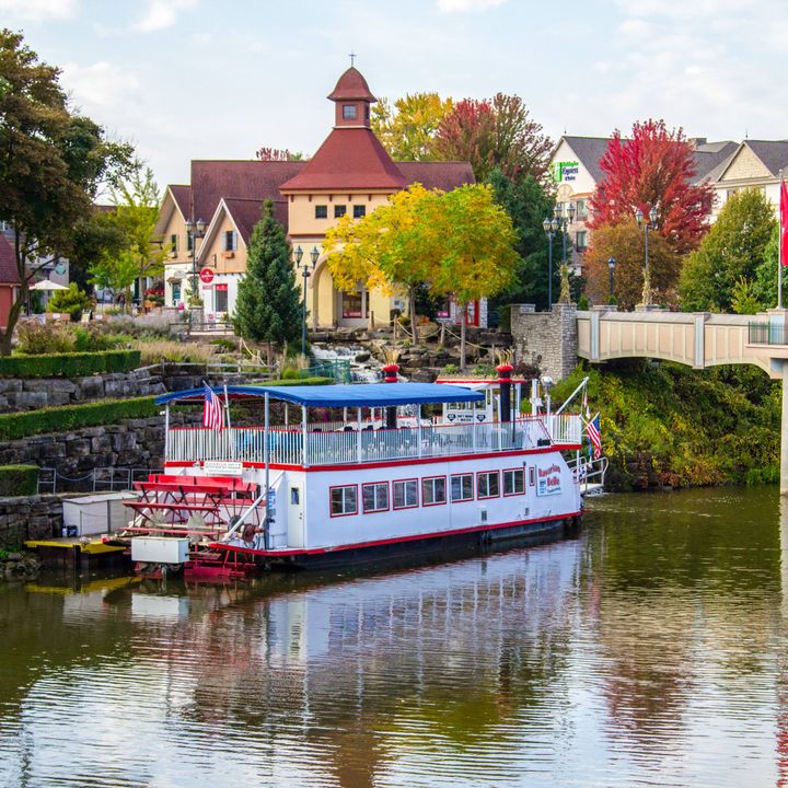 A river boat floats along the water in Frankenmuth, Michigan with its atmospheric Bavarian architecture.