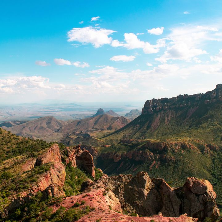A scenic panoramic view over Big Bend National Park with canyons and trees from Lost Mine Trail.
